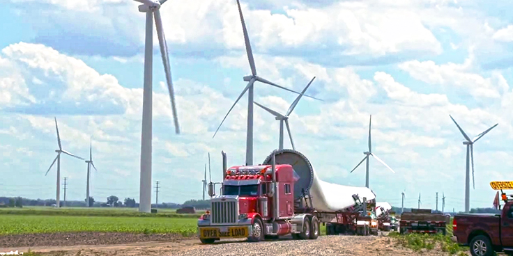 trucks delivering propeller to site